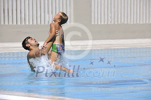 happy father and son have fun at swimming pool