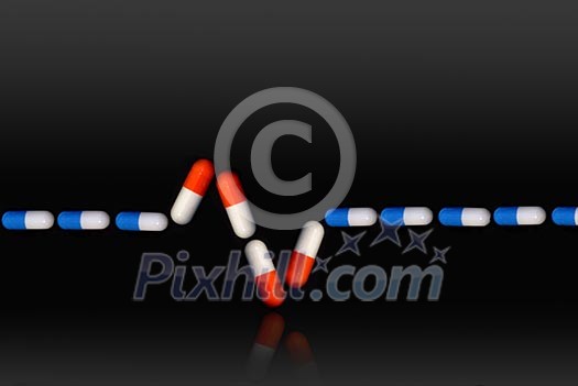 ekg sign with blue and red pills ekg sign with blue and red pills