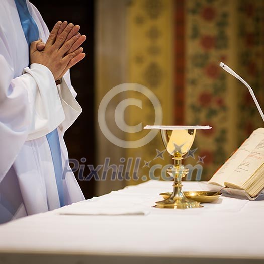 Priest during a wedding ceremony/nuptial mass Priest during a wedding ceremony/nuptial mass