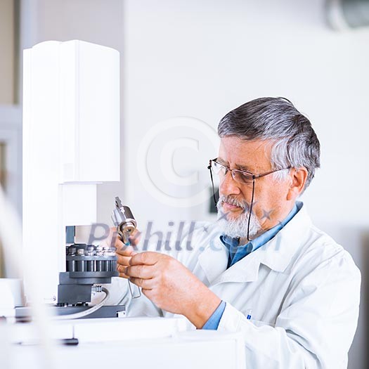 senior male researcher carrying out scientific research in a lab using a gas chromatograph (shallow DOF; color toned image) senior male researcher carrying out scientific research in a lab using a gas chromatograph (shallow DOF; color toned image)