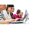 College students sitting in a classroom, using laptop computers during class (shallow DOF)