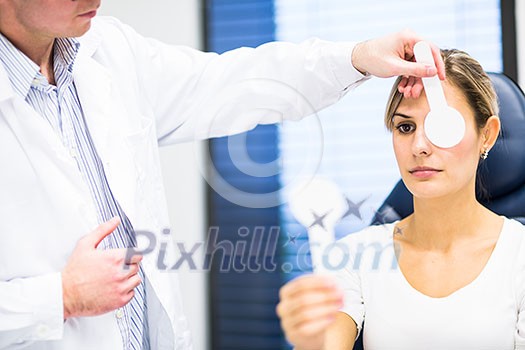 Optometry concept - pretty young woman having her eyes examined by an eye doctor Optometry concept - pretty young woman having her eyes examined by an eye doctor