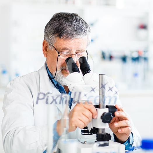 senior male researcher carrying out scientific research in a lab using a microscope (shallow DOF; color toned image) senior male researcher carrying out scientific research in a lab using a microscope (shallow DOF; color toned image)