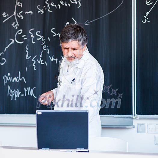 Senior chemistry professor writing on the board while having a chalk and blackboard lecture (shallow DOF; color toned image) Senior chemistry professor writing on the board while having a chalk and blackboard lecture (shallow DOF; color toned image)