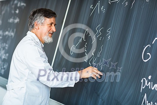 Senior chemistry professor writing on the board while having a chalk and blackboard lecture (shallow DOF; color toned image)