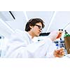 Young male researcher carrying out scientific research in a lab (shallow DOF; color toned image)