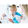 Two female researchers working in a laboratory (color toned image)