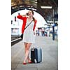 Pretty young woman at a train station