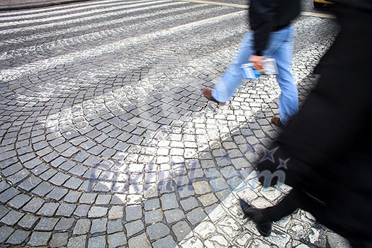 urban traffic concept - city street with a motion blurred crowd crossing a road