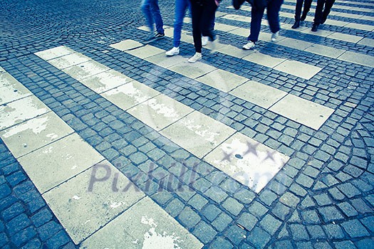 urban traffic concept - city street with a motion blurred crowd crossing a road