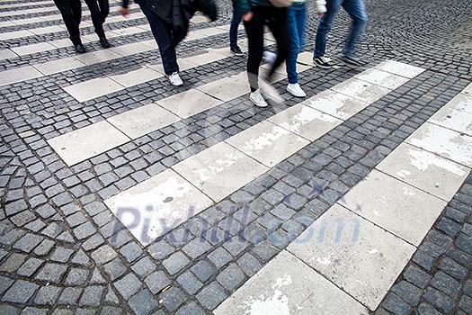 urban traffic concept - city street with a motion blurred crowd crossing a road