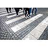 urban traffic concept - city street with a motion blurred crowd crossing a road