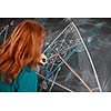 pretty young college student writing on the chalkboard/blackboard during a math class (color toned image; shallow DOF)