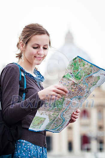 Pretty young female tourist studying a map at St. Peter's square in the Vatican City in Rome Pretty young female tourist studying a map at St. Peter's square in the Vatican City in Rome