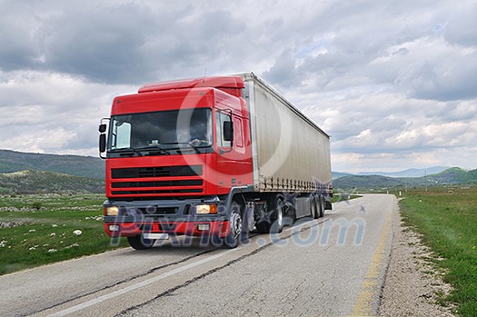big delivery cargo  red truck on road drive fast