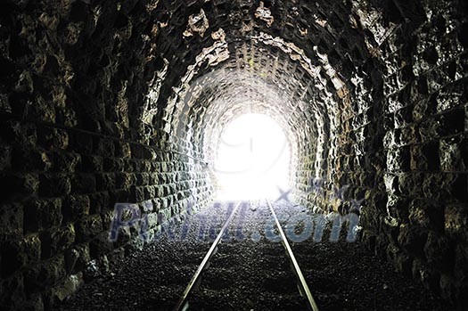 light on end of train tunnel representing new life and success concept