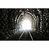 light on end of train tunnel representing new life and success concept