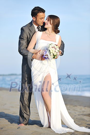 happy just married young couple celebrating and have fun at beautiful beach sunset happy just married young couple celebrating and have fun at beautiful beach sunset