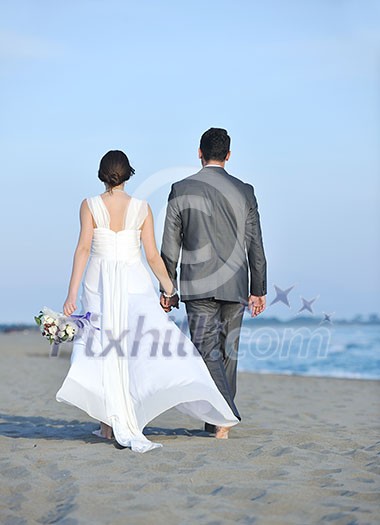 happy just married young couple celebrating and have fun at beautiful beach sunset happy just married young couple celebrating and have fun at beautiful beach sunset