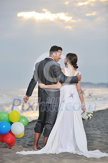 happy just married young couple celebrating and have fun at beautiful beach sunset happy just married young couple celebrating and have fun at beautiful beach sunset