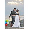 happy just married young couple celebrating and have fun at beautiful beach sunset