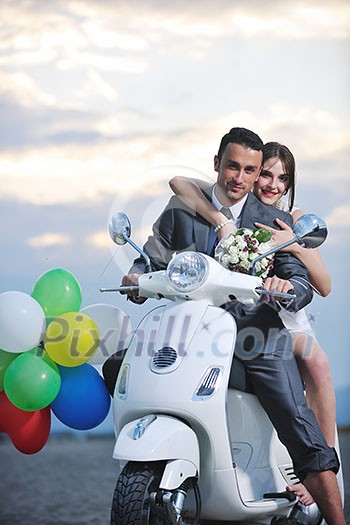 wedding sce of bride and groom just married couple on the beach ride white scooter and have fun wedding sce of bride and groom just married couple on the beach ride white scooter and have fun