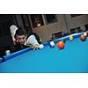 young pro billiard player finding best solution and right angle at billard or snooker pool sport  game 