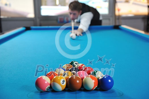 young pro billiard player finding best solution and right angle at billard or snooker pool sport  game 