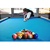 young pro billiard player finding best solution and right angle at billard or snooker pool sport  game 