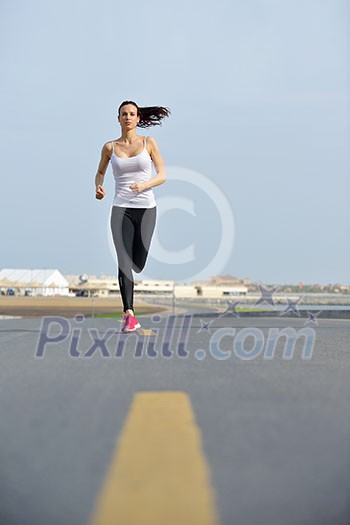 Running in city park. Woman runner outside jogging at morning with Dubai urban scene in background