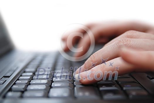 Isolated female hand typing on laptop keyboard