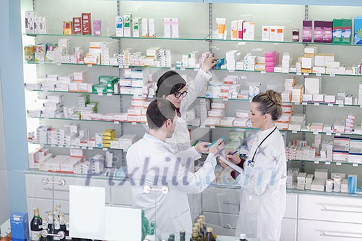 team of  pharmacist chemist woman and man  group  standing in pharmacy drugstore