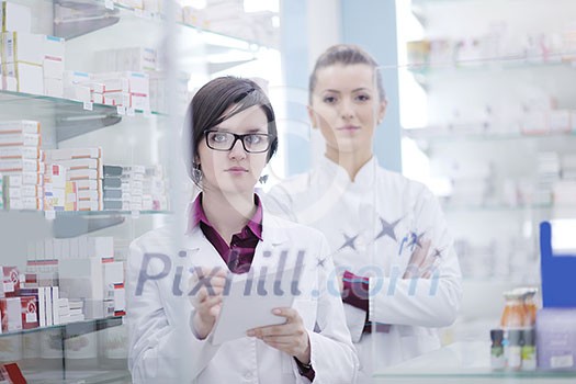 team of pharmacist chemist woman group standing in pharmacy drugstore team of pharmacist chemist woman group standing in pharmacy drugstore