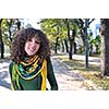 brunette Cute young woman with colorful scarf smiling outdoors in nature
