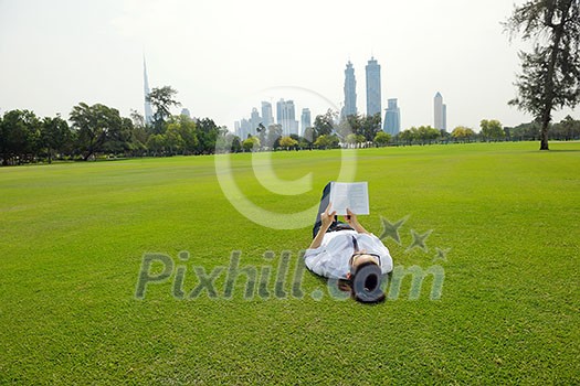 Young student woman reading a book and study in the park Young student woman reading a book and study in the park