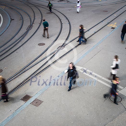 urban traffic concept - city street with a motion blurred crowd crossing a road