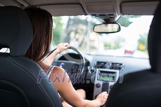 Young, woman driving a car, going home from work