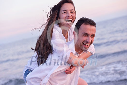 happy young romantic couple in love have fun on beautiful beach at beautiful summer day