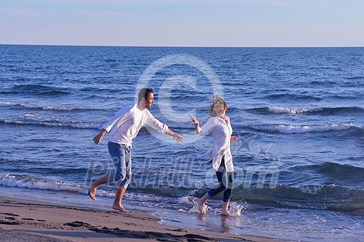 happy young romantic couple in love have fun on beautiful beach at beautiful summer day