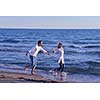 happy young romantic couple in love have fun on beautiful beach at beautiful summer day