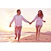 happy young romantic couple in love have fun on beautiful beach at beautiful summer day