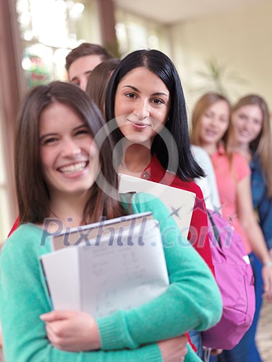 happy young teens group in school on chemisty lessons and library education