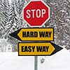 hard and easy way road sign in nature