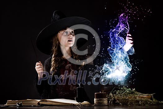 Little Halloween witch reading conjure above pot