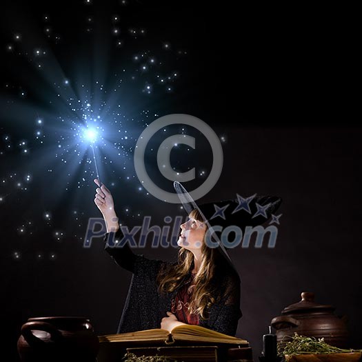 Little Halloween witch reading conjure from magic book