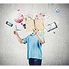 Young man in casual holding opened book with icons flying out