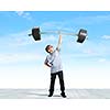 Cute boy of school age lifting barbell above head