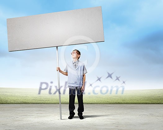 Young man on road holding blank banner. Place for text