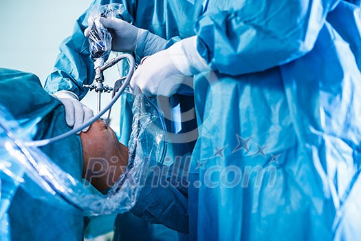 Knee surgery, Orthopedic Operation  - two surgeons performing a knee surgery on a patient (shallow DOF; color toned image)