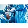 Knee surgery, Orthopedic Operation  - two surgeons performing a knee surgery on a patient (shallow DOF; color toned image)